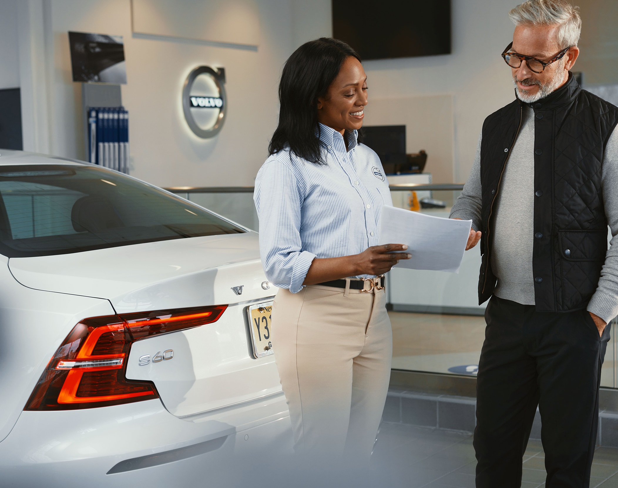 Woman talking to customer for volvo maintenance