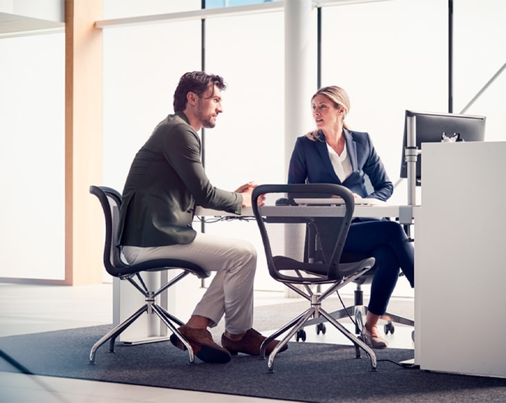 Certified by Volvo Service Contract Contracts man and woman talking at a certified service desk