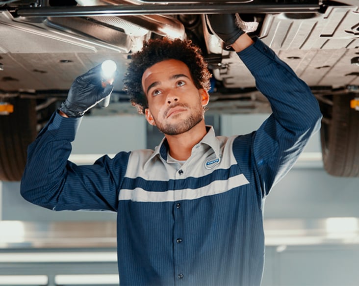 Prepaid Maintenance man inspecting car