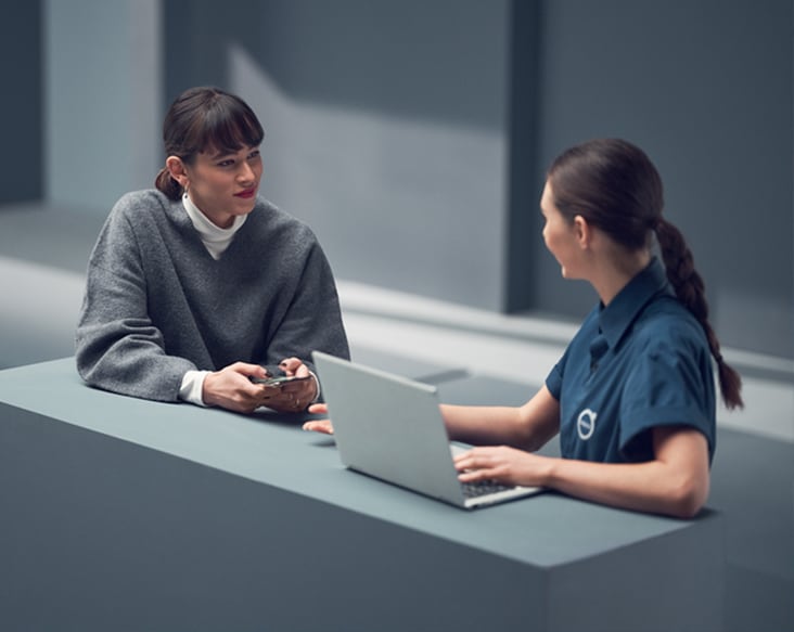 Extended Vehicle Service Contracts two women talking at a service desk